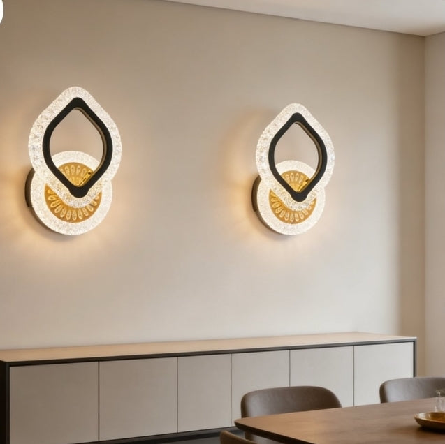 Modern wall sconces on a neutral wall with a dining area in the foreground