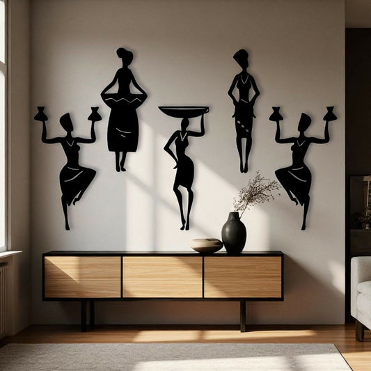Black silhouette wall art of women on a wall above a wooden console table.