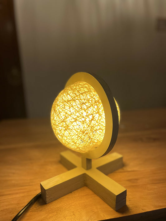 Decorative lamp with wicker design on a wooden base