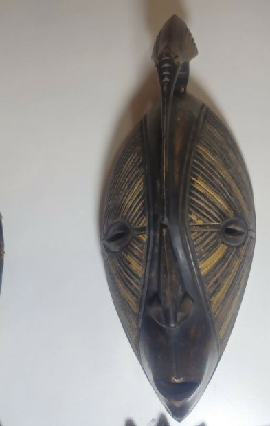 Wooden wall mask with intricate carvings