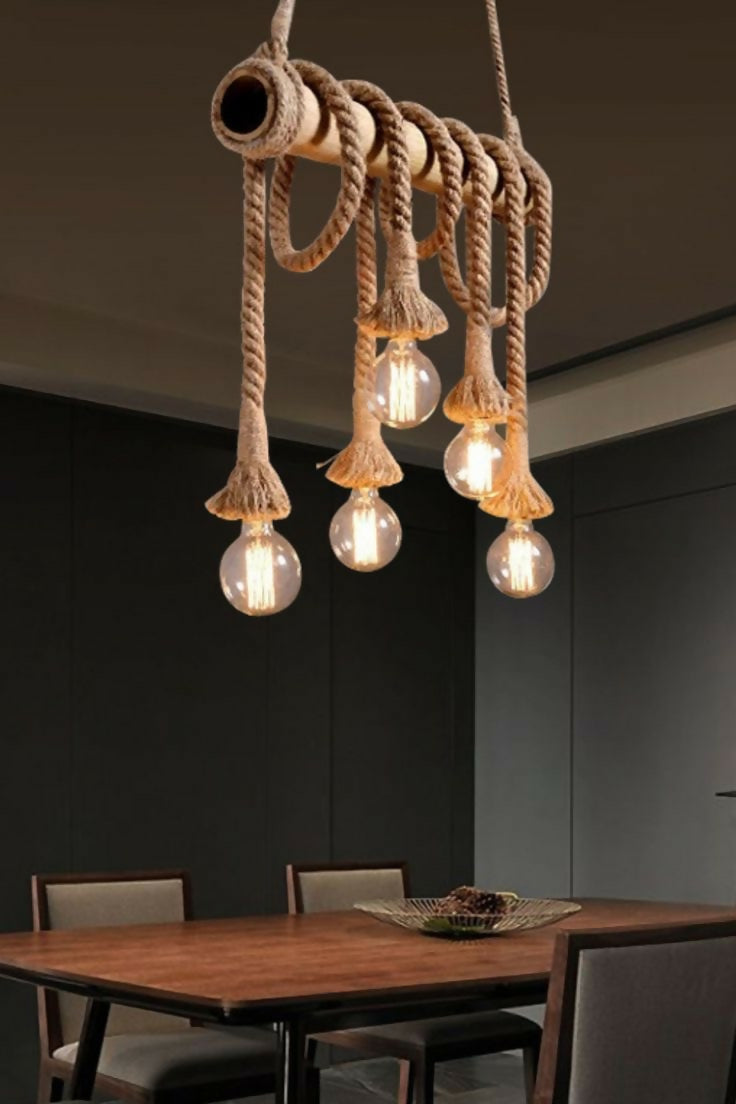 Rustic pendant light with multiple bulbs hanging above a dining table.