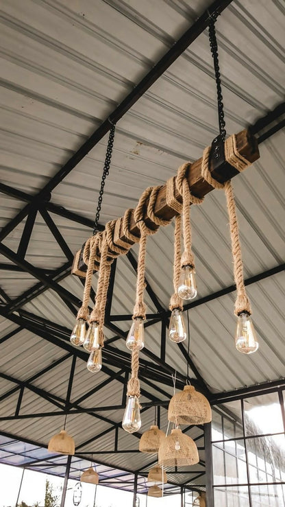 Rustic pendant lightmade of rope and wooden elements hanging from a ceiling.