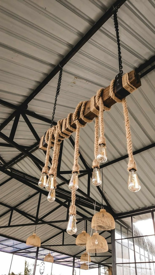 Rustic pendant lightmade of rope and wooden elements hanging from a ceiling.