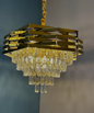 Gold chandelier with crystal accents against a dark background