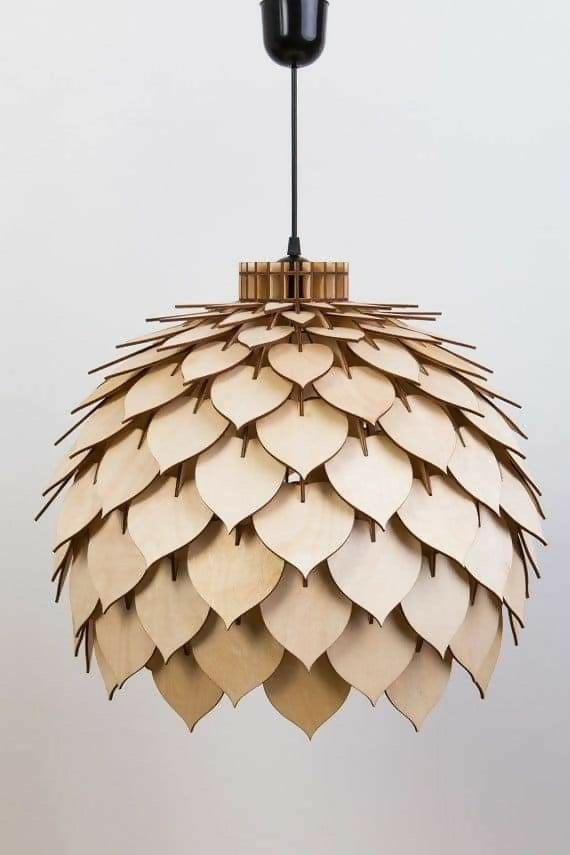 Wooden pendant light with leaf-like design on a plain background