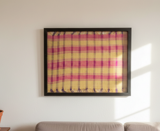 Framed yellow and pink checkered fabric on a white background