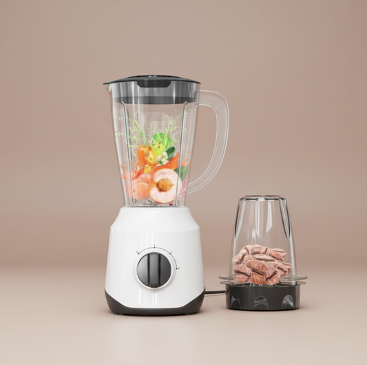 White blender with a clear container filled with fruits and vegetables on a white background