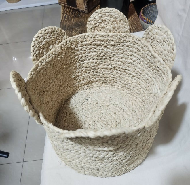 Woven basket with a textured surface on a light-colored floor.