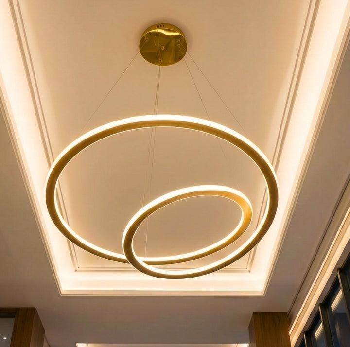 Modern ceiling light fixture with three circular rings on a white ceiling.
