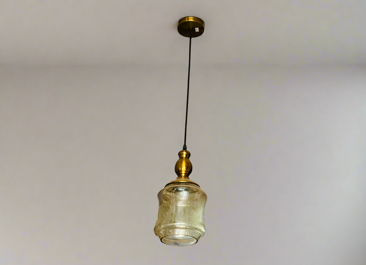 Amangazini golden cage pendant light with a vintage glass shade and brass detailing hanging from the ceiling