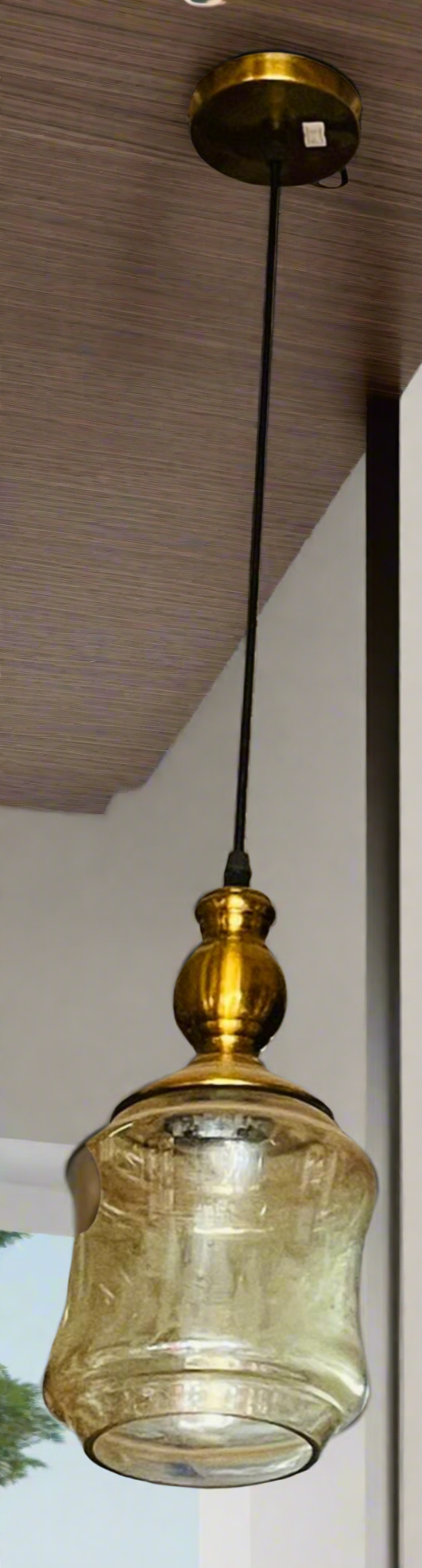 Amangazini golden cage pendant light featuring a glass shade and elegant gold finish
