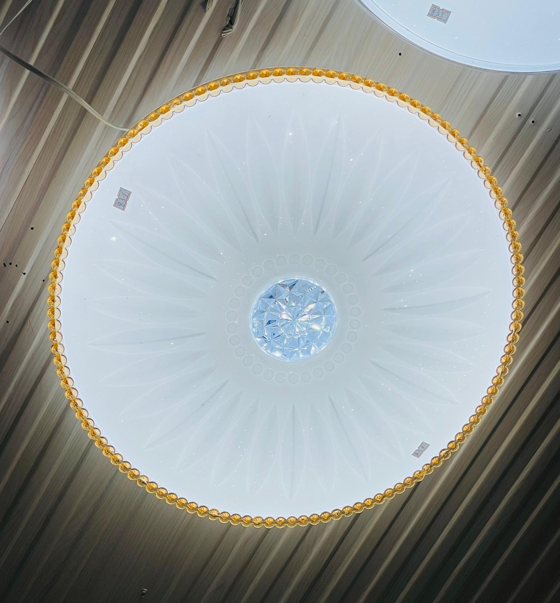 Elegant golden ceiling light with unique floral design and crystal center for modern interiors