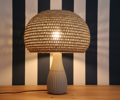 Woven basket hanging against a blue and white striped wall