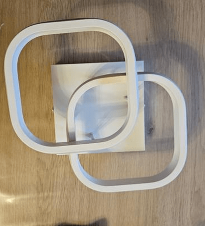 Amangazini intersecting wall light design in white featuring two overlapping squares