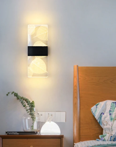 Amangazini leaf motif wall panel lighting illuminating a cozy bedroom with a wooden bed frame