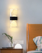 Amangazini leaf motif wall panel lighting illuminating a cozy bedroom with a wooden bed frame