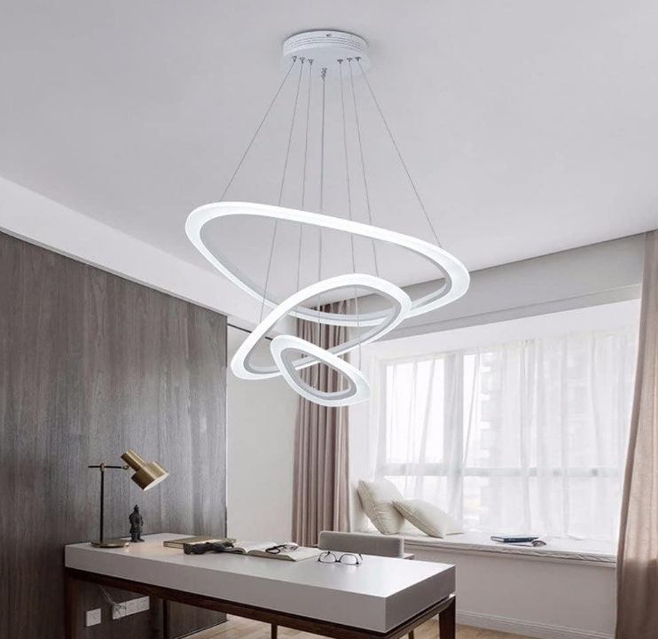 Modern Cascading LED Ring Chandelier hanging above a contemporary office desk with natural light