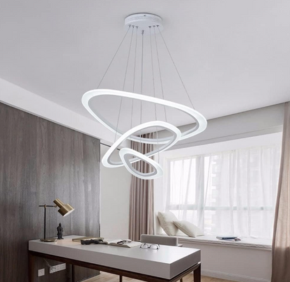 Modern Cascading LED Ring Chandelier hanging above a contemporary office desk with natural light