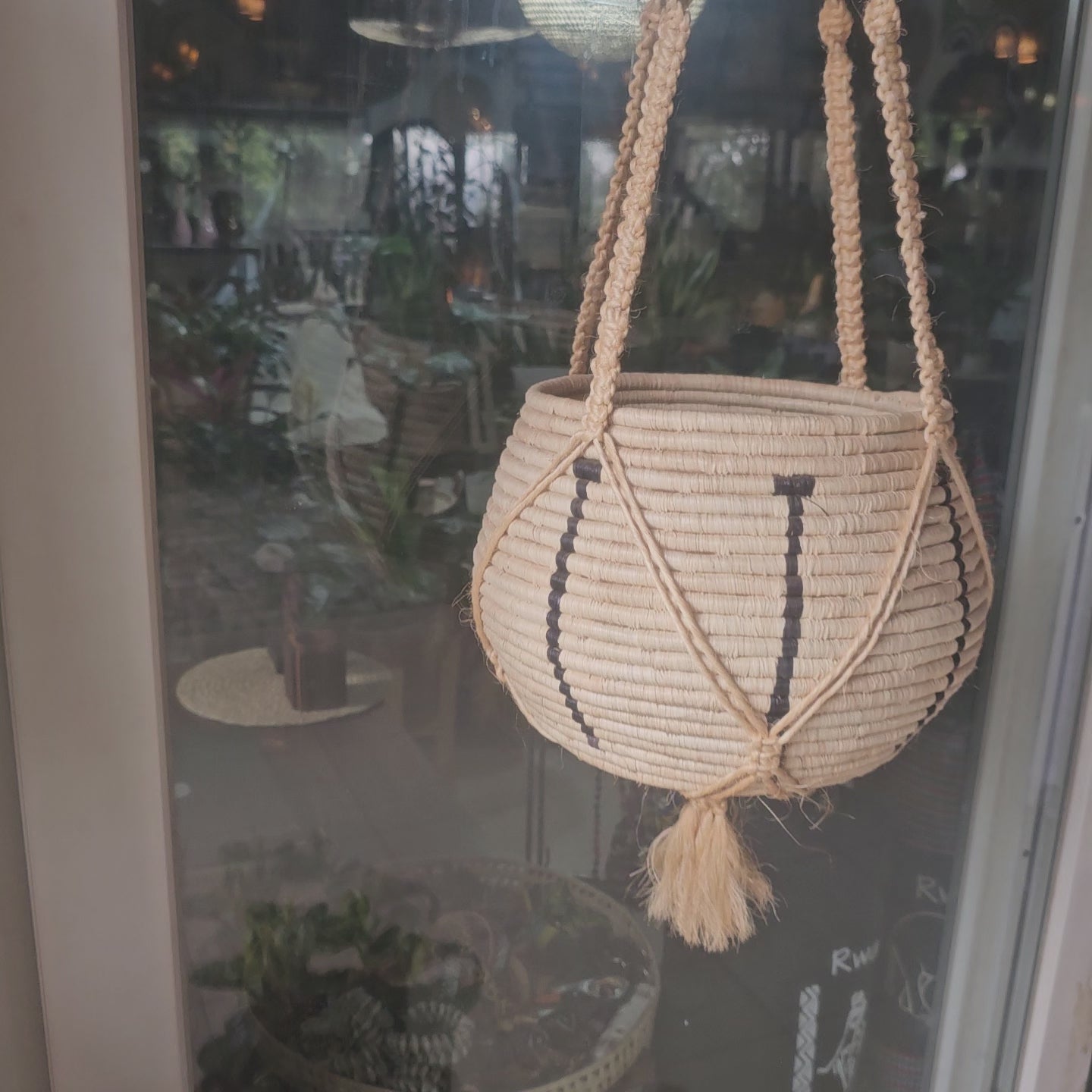 a hanging raffia basket made in rwanda
