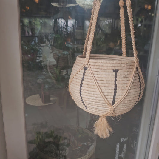 a hanging raffia basket made in rwanda