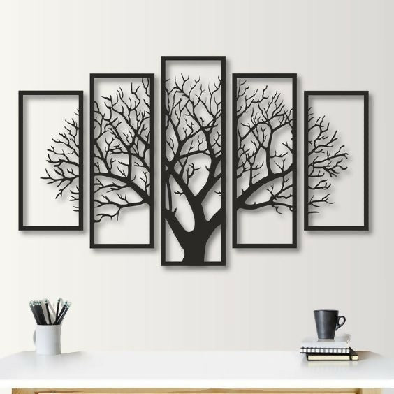 Set of five framed black tree silhouettes on a white wall.