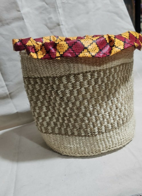 Woven basket with a colorful floral lid on a white background