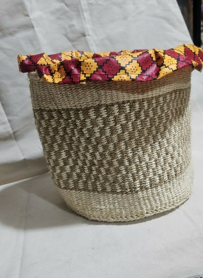 Woven basket with a colorful floral lid on a white background