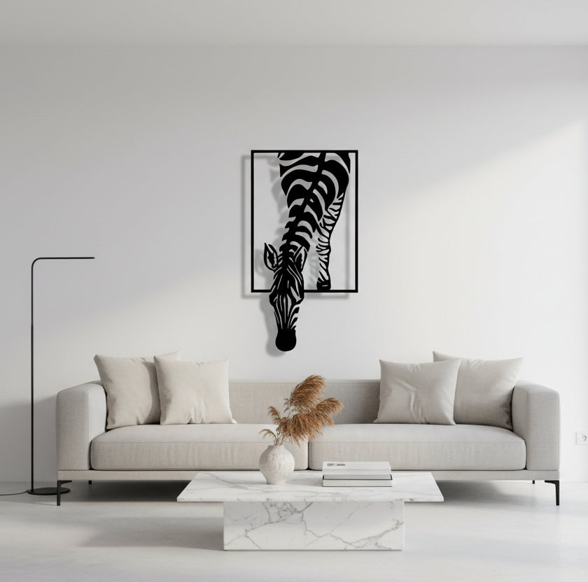 Metal wall art of a zebra with a black frame on a white background