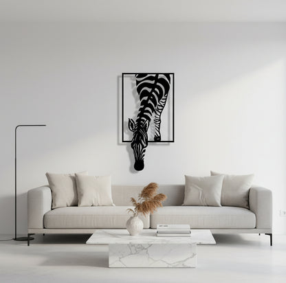 Metal wall art of a zebra with a black frame on a white background