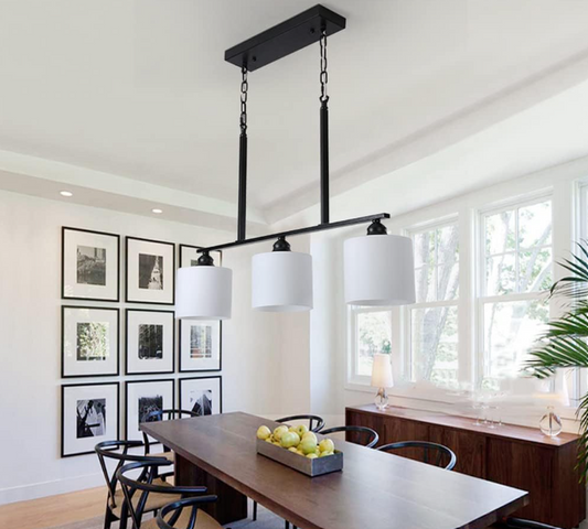 Amangazini Trilight pendant lighting with three white shades hanging above a modern dining table