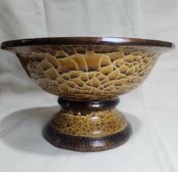 Ceramic bowl with textured brown design on a white background