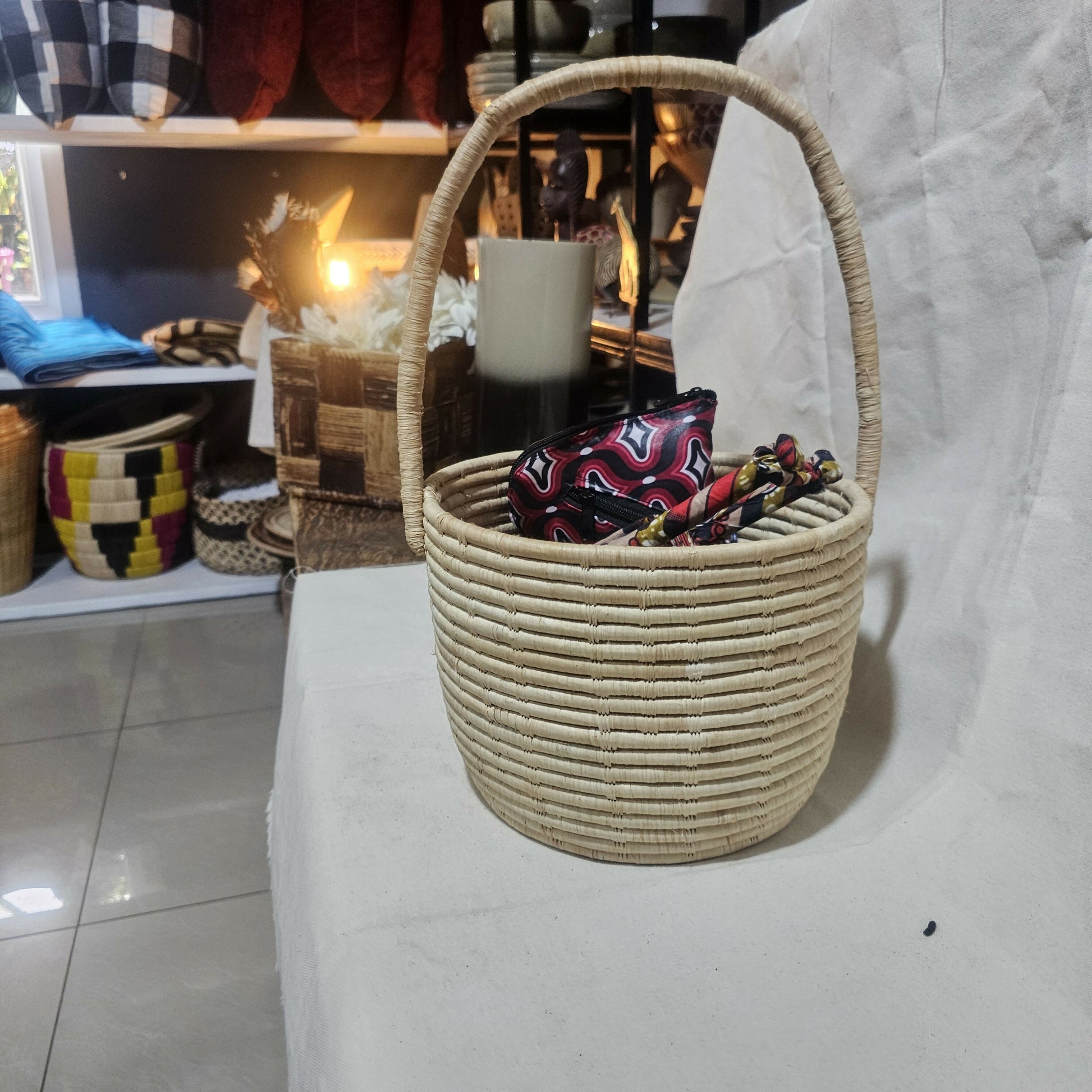 Woven basket with a colorful bag inside on a white surface, with blurred background