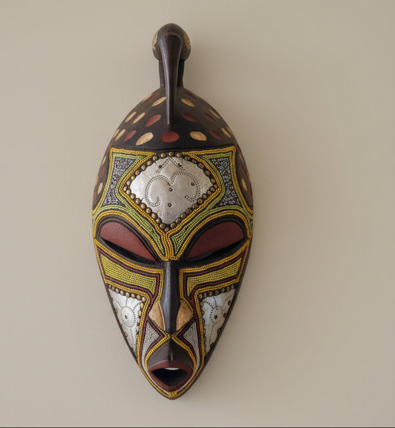 Decorative mask with intricate patterns on a white background