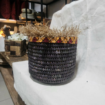 Woven basket with decorative rim on a white surface