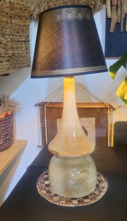 Decorative lamp with a dark shade on a table